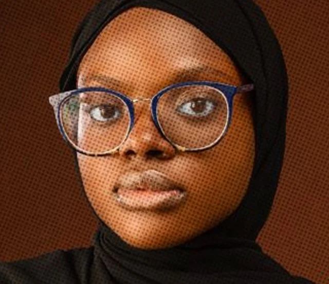 Portrait of Aminat Afolabi in glasses and a black hijab